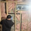 Technician repairing basement foundation crack in Toronto home.