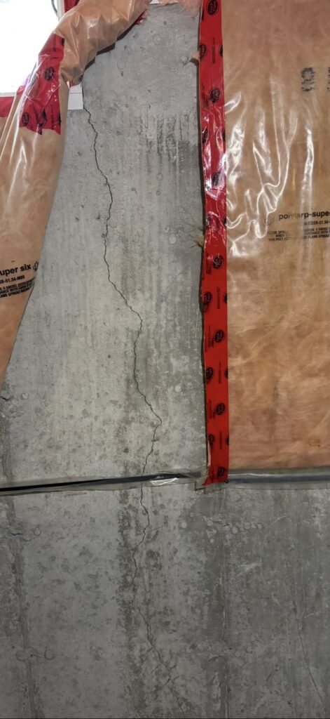 Poured concrete crack in foundation wall.