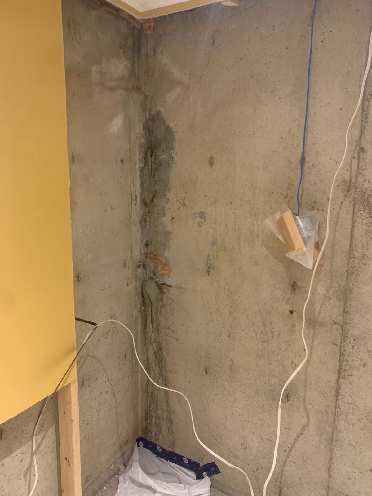 Leaking basement corner crack with an earlier surface patch that failed, before re-injection
