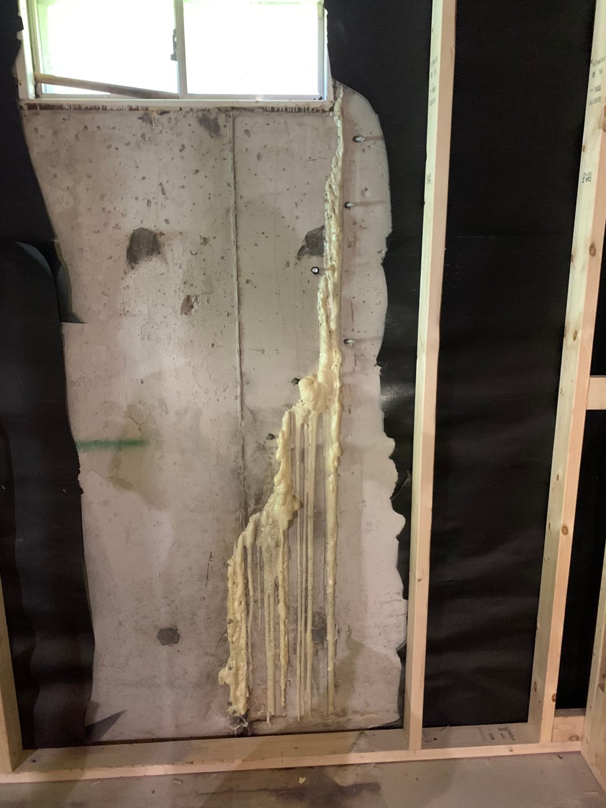 Foundation wall crack after polyurethane resin was injected through metal ports