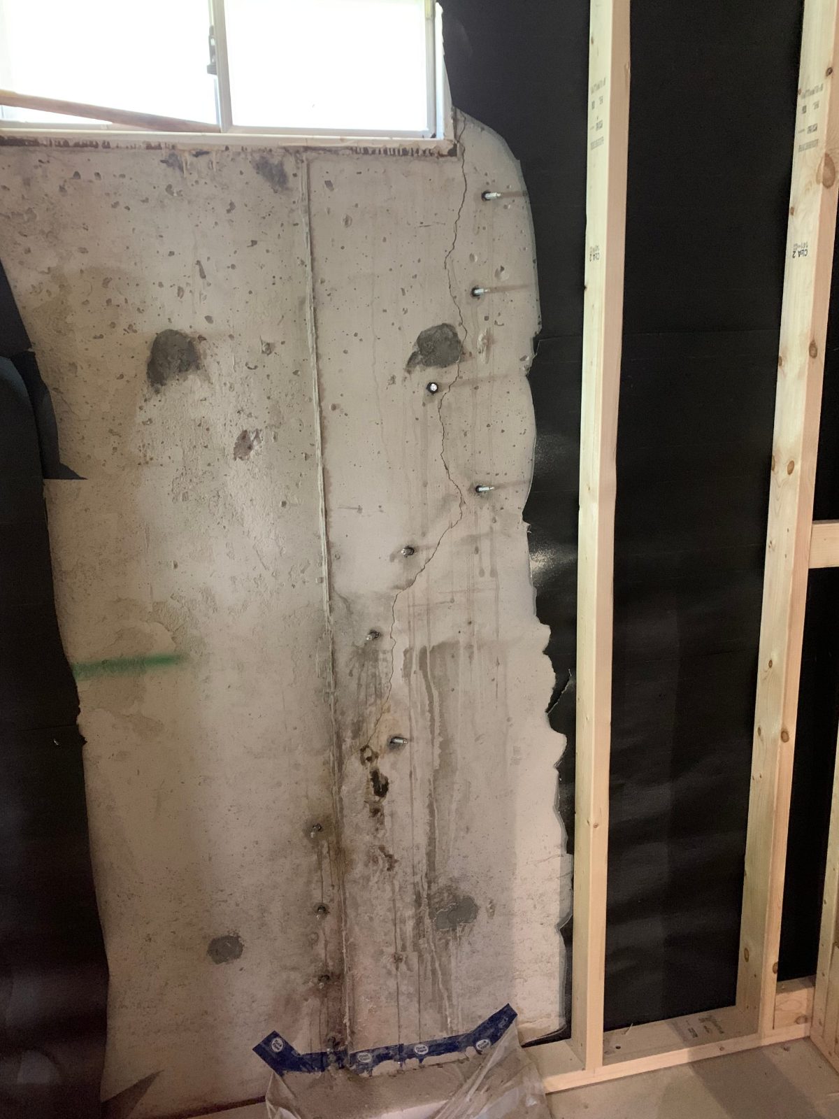 Metal injection ports installed along a foundation wall crack, ready for crack injection